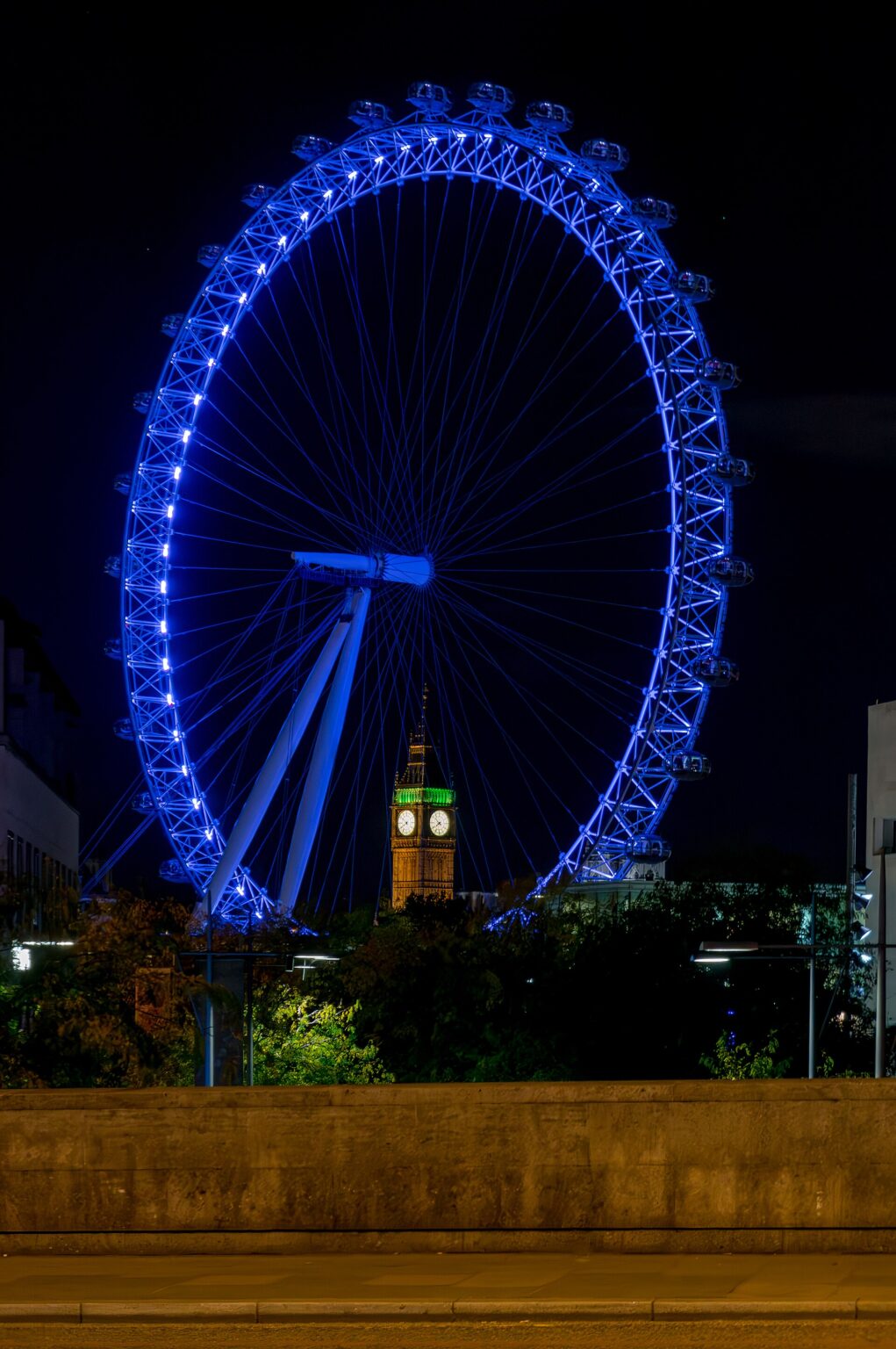 Il London Eye illuminato di sera con il Big Ben